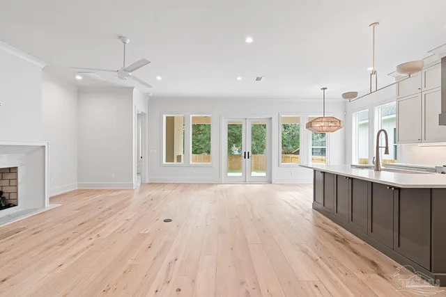 a large kitchen with kitchen island a sink stainless steel appliances and cabinets
