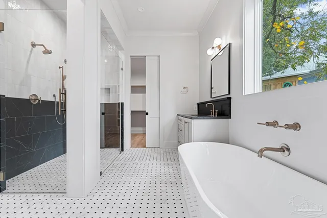 a kitchen with white cabinets and sink