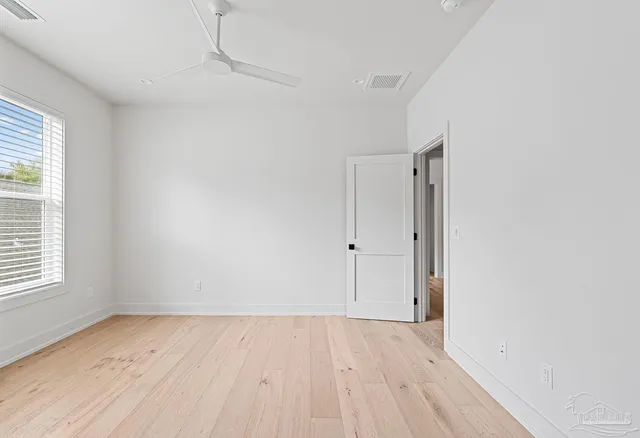 a view of an empty room and wooden floor