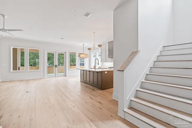 a view of bathroom with a sink mirror and window