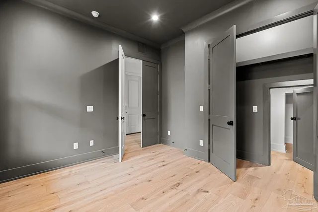 a large kitchen with stainless steel appliances kitchen island a large counter top and a wooden floors