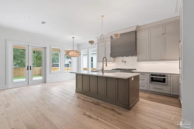 a view of a kitchen with a sink wooden floor and a fireplace