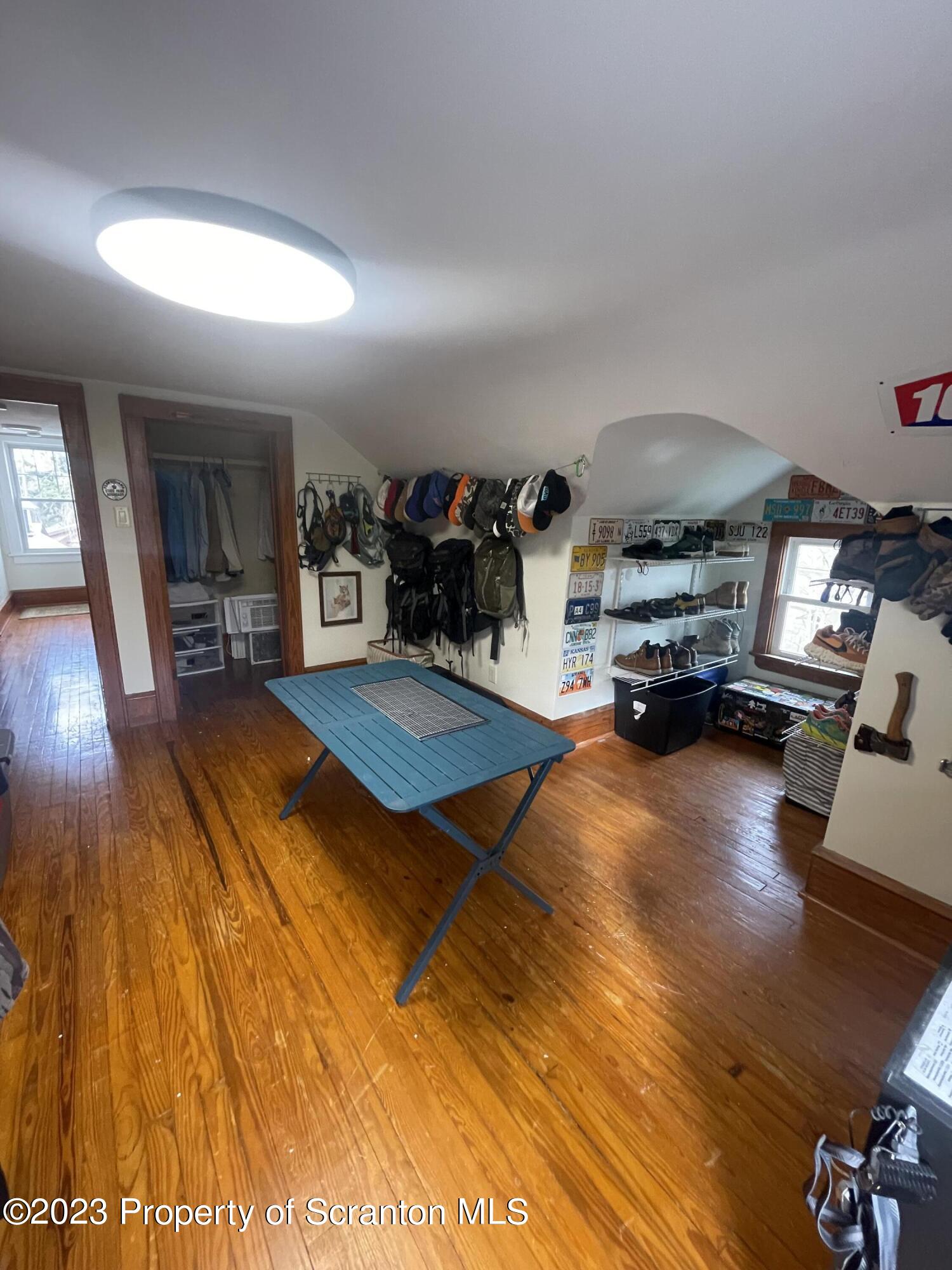 371 Bodle Road Wyoming, PA 18644 - Photo 14 of 17 a gym area with furniture and a wooden floor