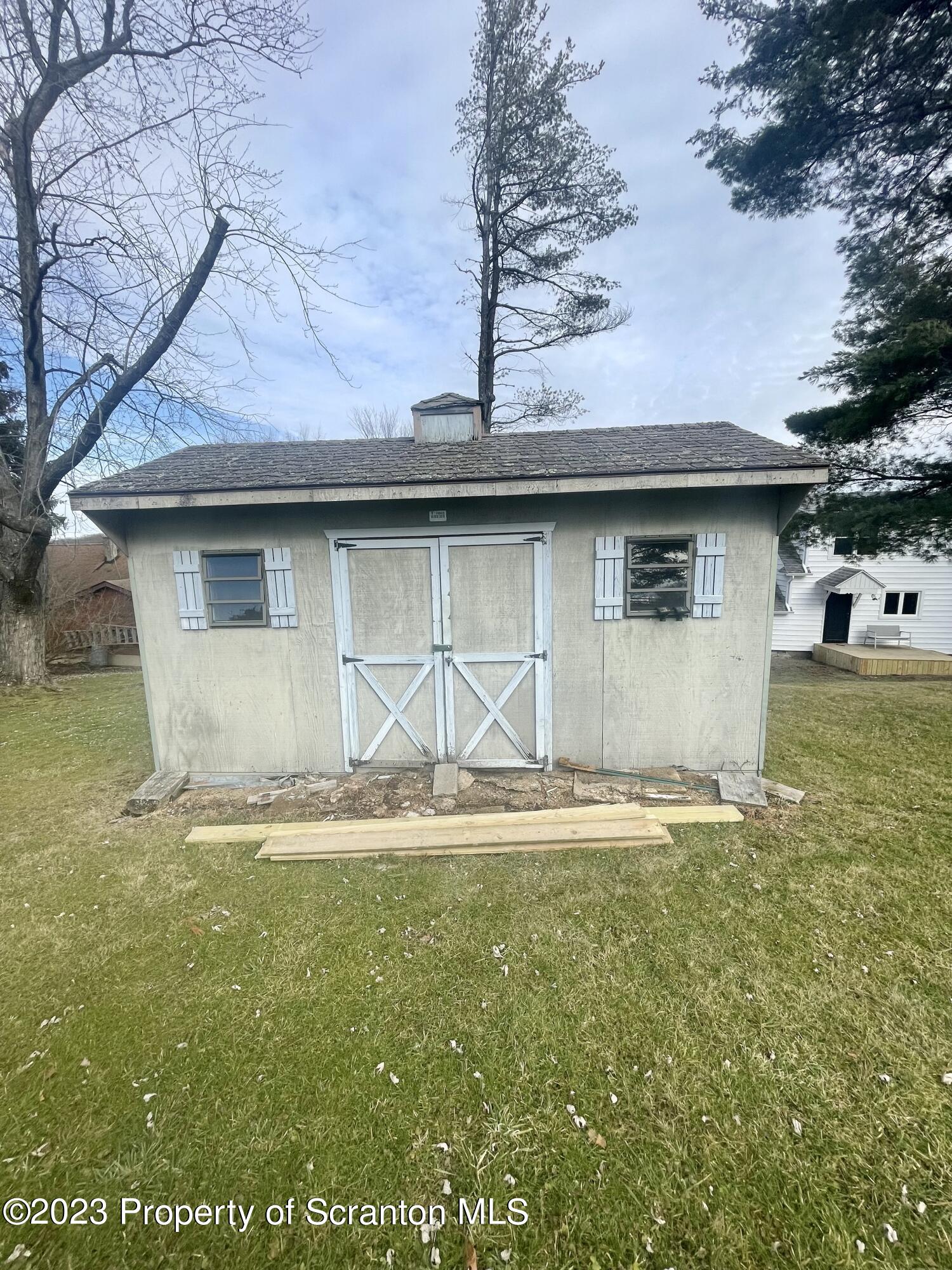 371 Bodle Road Wyoming, PA 18644 - Photo 16 of 17 a backyard of a house with table and chairs