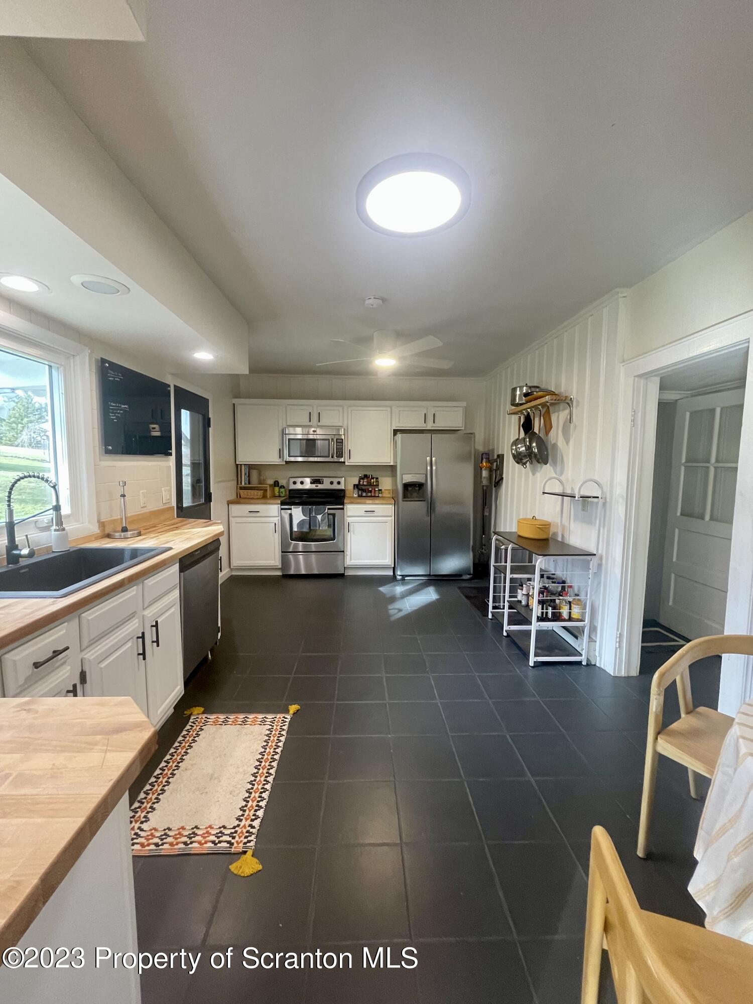371 Bodle Road Wyoming, PA 18644 - Photo 6 of 17 a large kitchen with stainless steel appliances kitchen island granite countertop a sink and cabinets