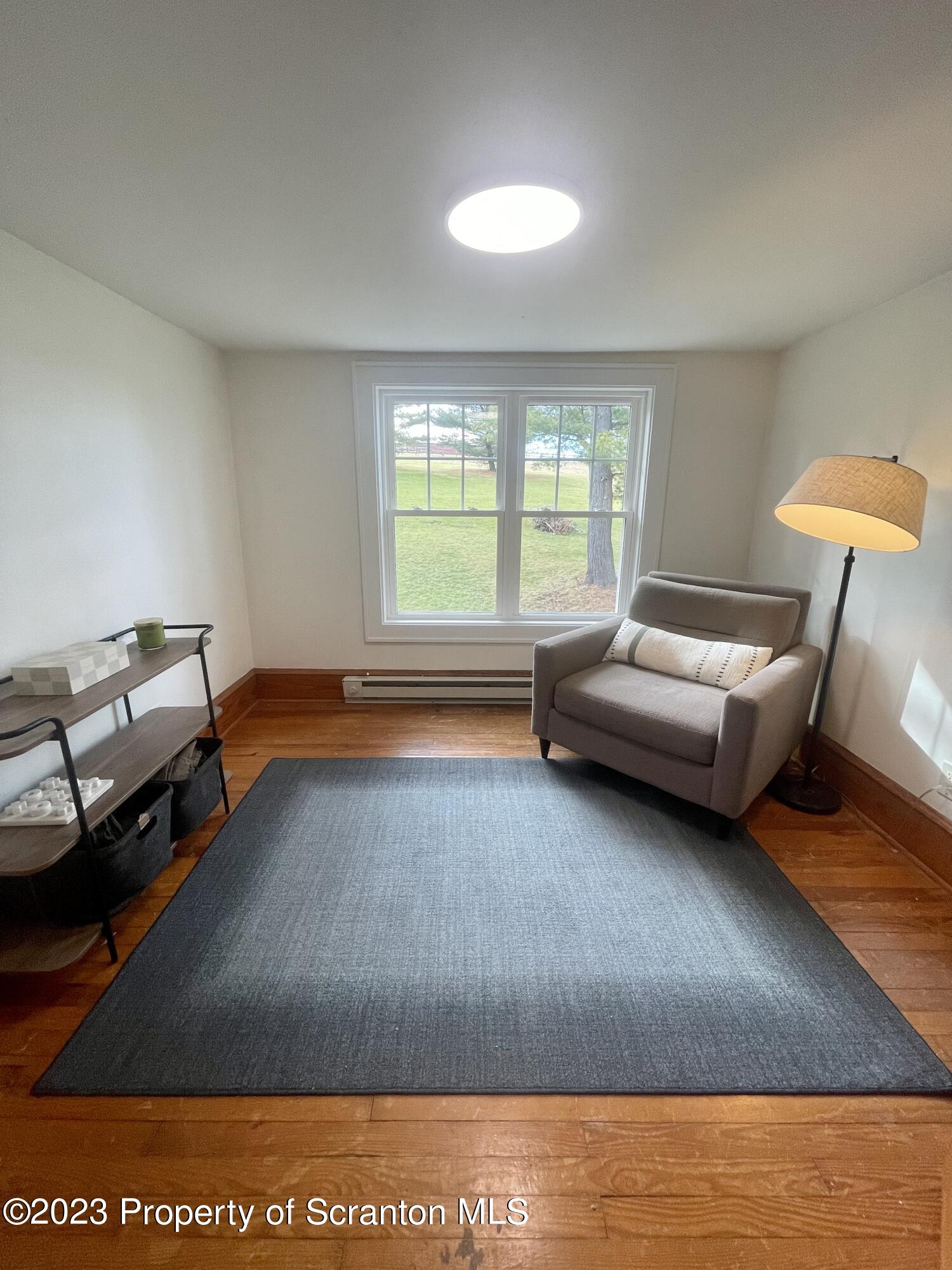 371 Bodle Road Wyoming, PA 18644 - Photo 9 of 17 a living room with furniture and a window