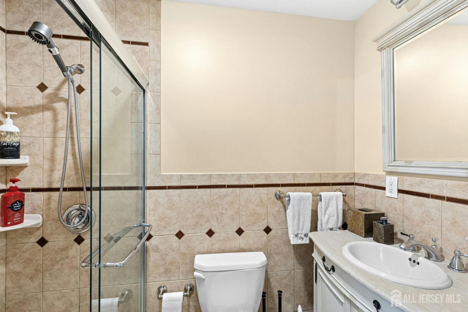1701 Raritan Road Scotch Plains, NJ 07076 - Photo 11 of 31 a bathroom with a sink toilet and shower