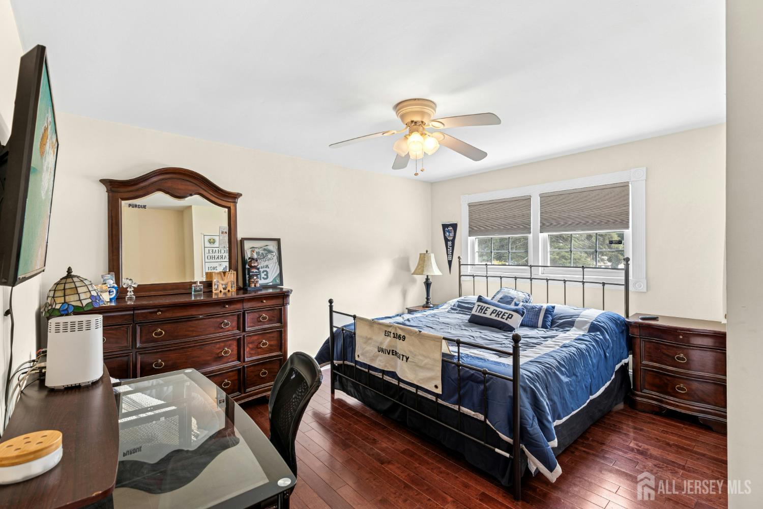 1701 Raritan Road Scotch Plains, NJ 07076 - Photo 12 of 31 a bedroom with a bed and a chandelier