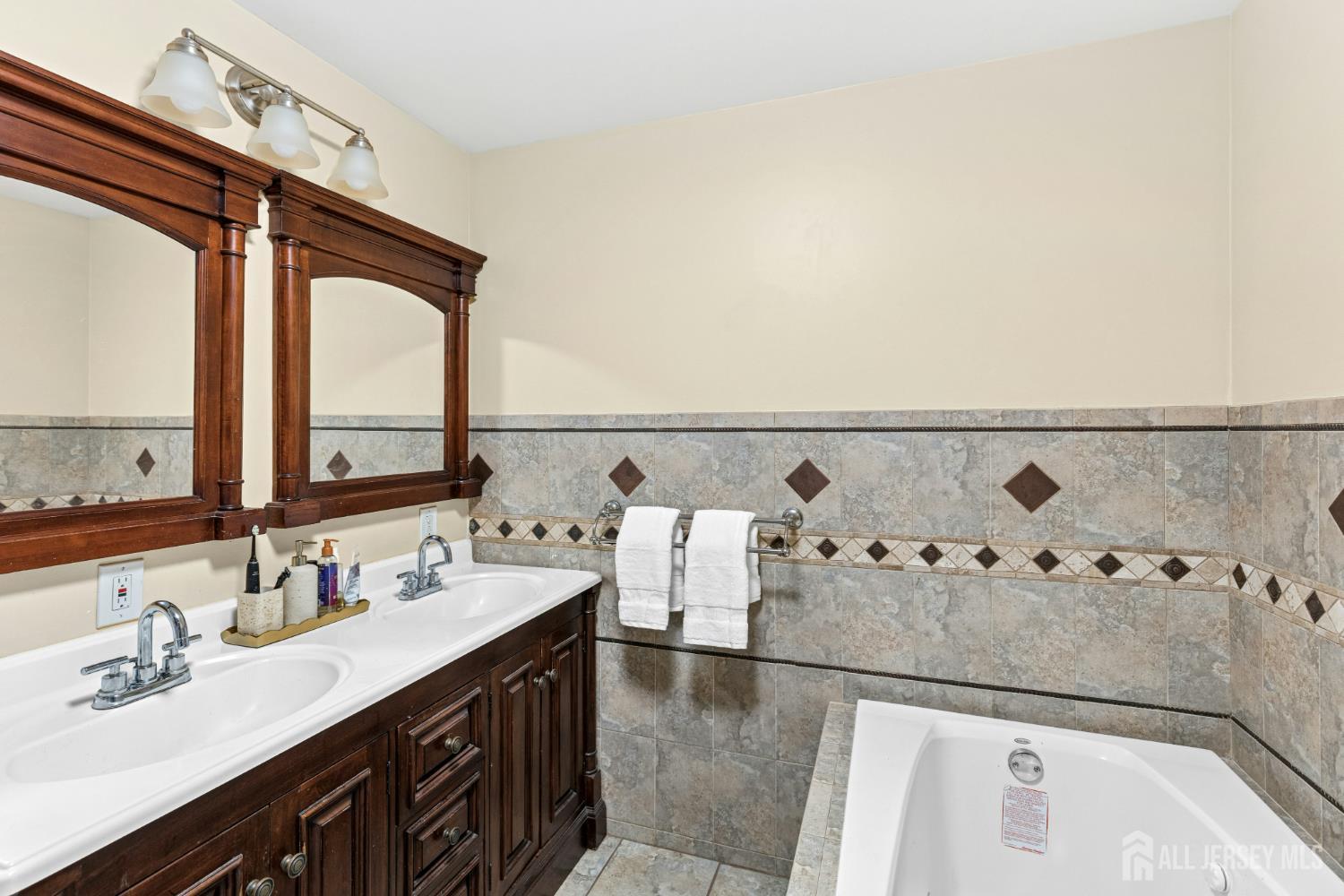 1701 Raritan Road Scotch Plains, NJ 07076 - Photo 18 of 31 a bathroom with a sink and a mirror