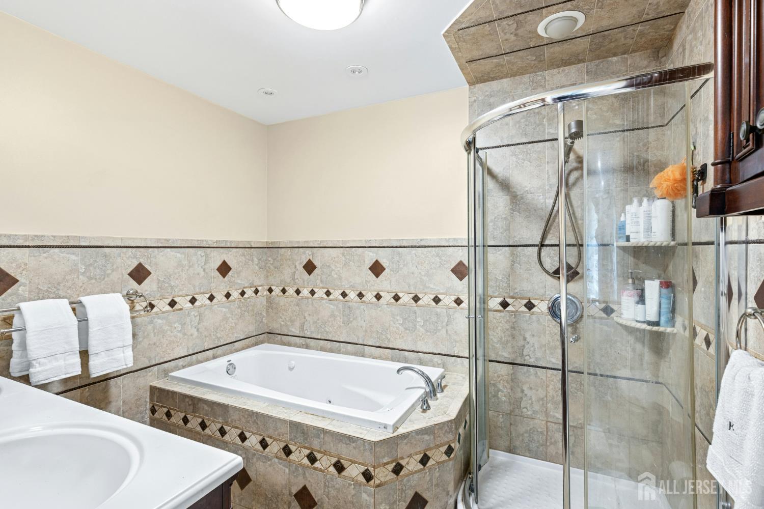 1701 Raritan Road Scotch Plains, NJ 07076 - Photo 19 of 31 a bathroom with a bathtub and shower