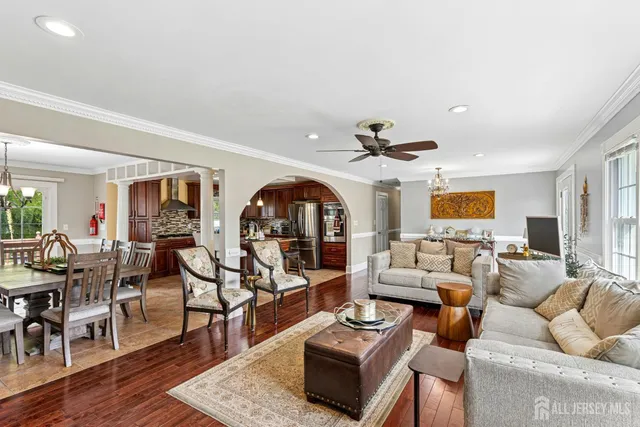 a living room with furniture a rug and a chandelier