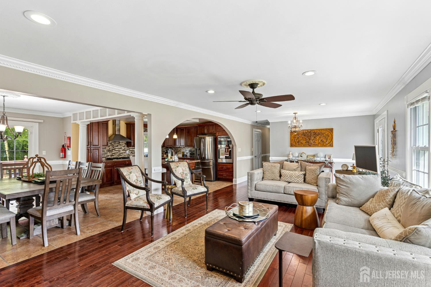 1701 Raritan Road Scotch Plains, NJ 07076 - Photo 4 of 31 a living room with furniture a rug and a chandelier