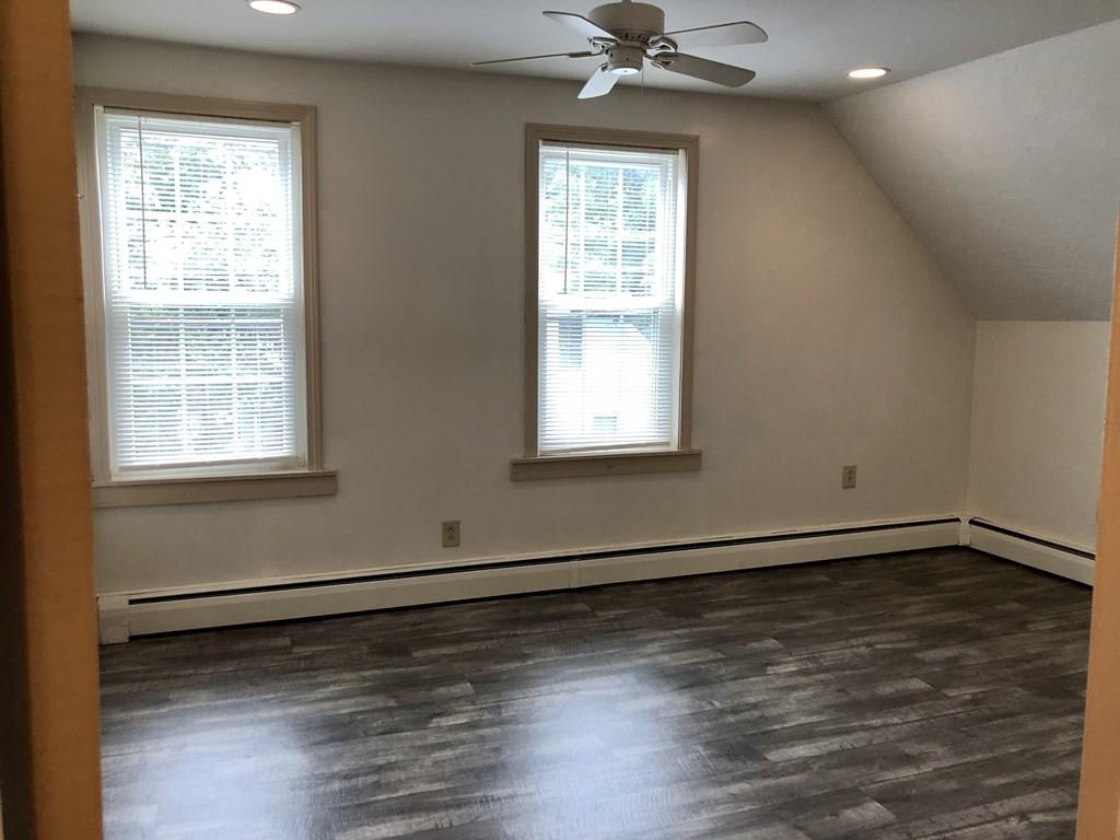 25 Baker Street Gardner, MA 01440 - Photo 18 of 26 a view of an empty room with wooden floor and a window