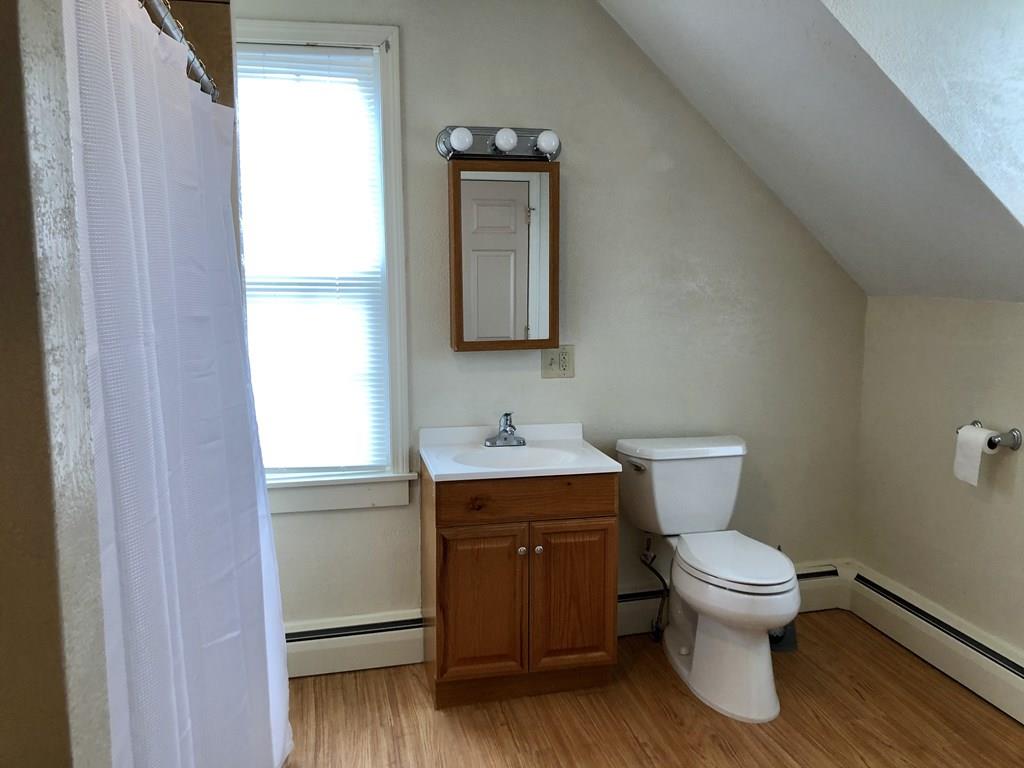 25 Baker Street Gardner, MA 01440 - Photo 22 of 26 a bathroom with a toilet sink and mirror