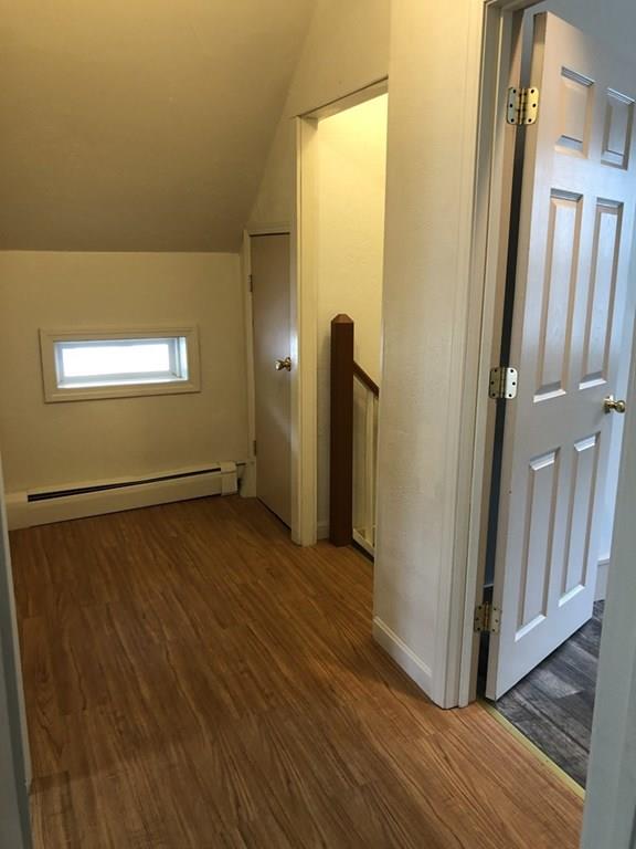 25 Baker Street Gardner, MA 01440 - Photo 25 of 26 a view of a hallway with wooden floor and a bathroom