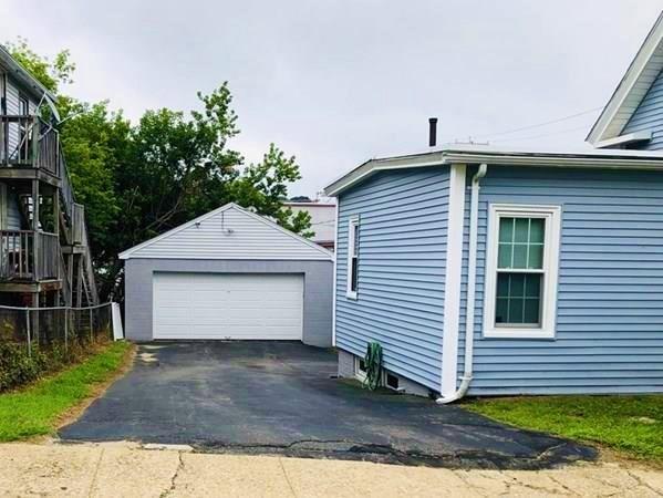 25 Baker Street Gardner, MA 01440 - Photo 4 of 26 a front view of a house with a yard and garage