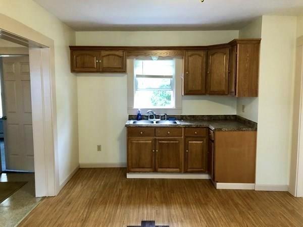25 Baker Street Gardner, MA 01440 - Photo 7 of 26 a kitchen with granite countertop wooden cabinets and a wooden floor