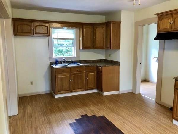 25 Baker Street Gardner, MA 01440 - Photo 8 of 26 a kitchen with stainless steel appliances granite countertop a sink a stove and a wooden floors