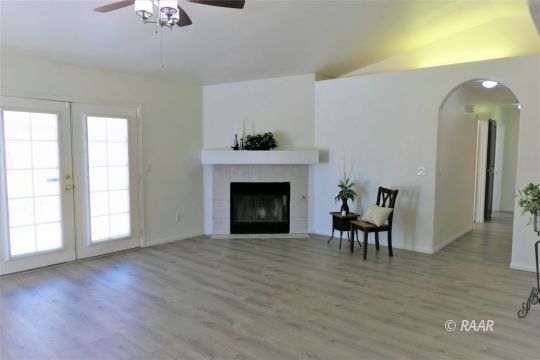 1420 South Yorktown Street Ridgecrest, CA 93555 - Photo 4 of 27 a view of an empty room with wooden floor and a window