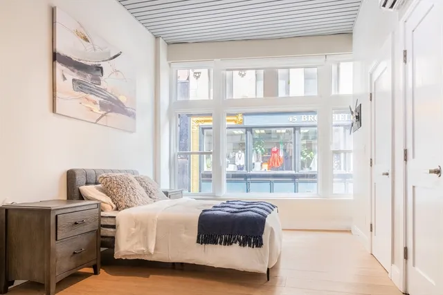 a bedroom with a bed and window