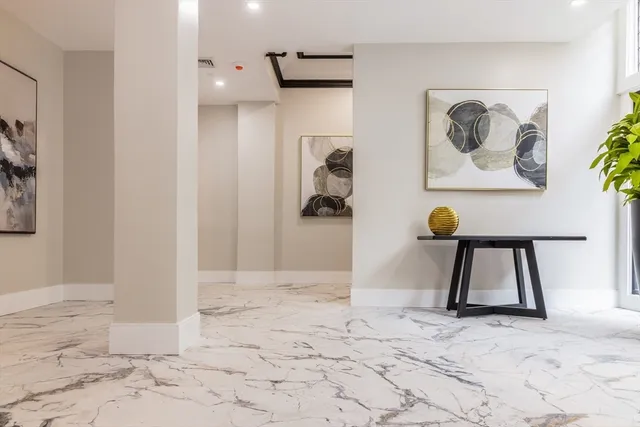 a view of a hallway with a painting on the wall