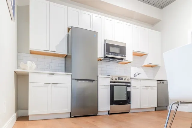 a kitchen with a refrigerator sink and microwave