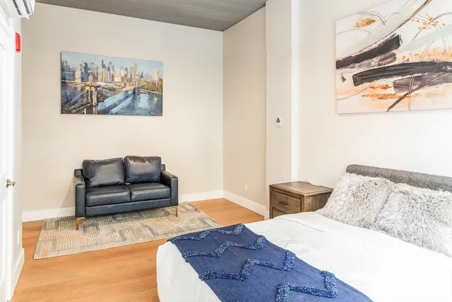 a bedroom with furniture and wooden floor