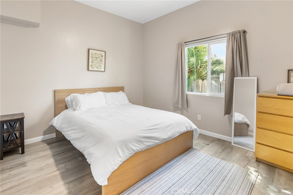 944 West 18th Street Merced, CA 95340 - Photo 12 of 34 a bedroom with a bed and wooden floor