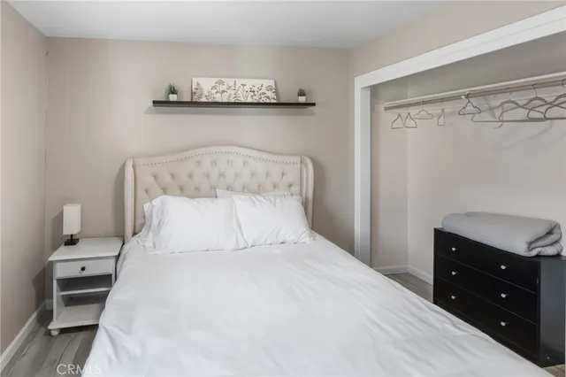 a bedroom with a bed and a night stand