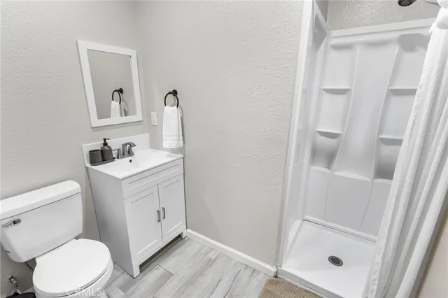 a white toilet sitting next to a bathroom sink