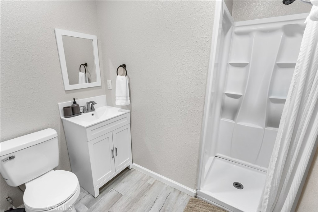 944 West 18th Street Merced, CA 95340 - Photo 17 of 34 a white toilet sitting next to a bathroom sink