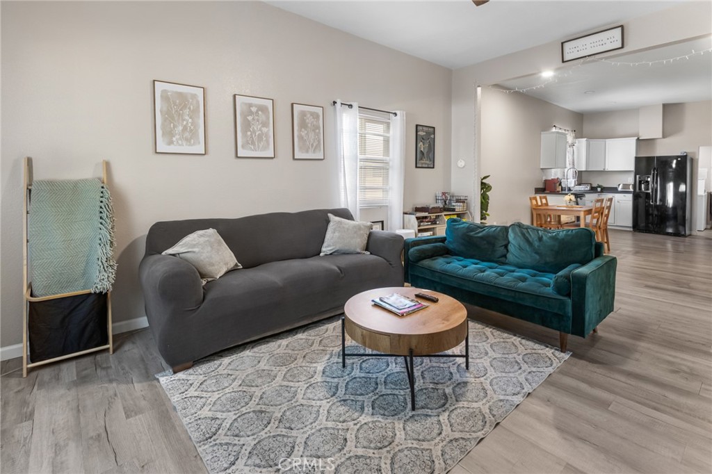 944 West 18th Street Merced, CA 95340 - Photo 3 of 34 a living room with furniture and a wooden floor