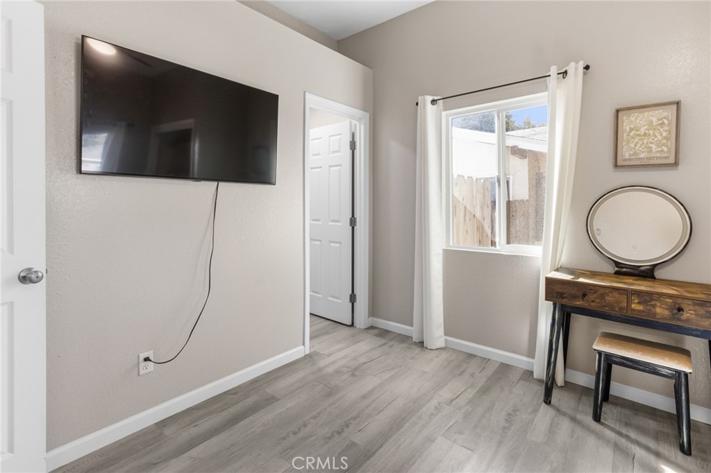 944 West 18th Street Merced, CA 95340 - Photo 7 of 34 a view of a livingroom with wooden floor and a bathroom
