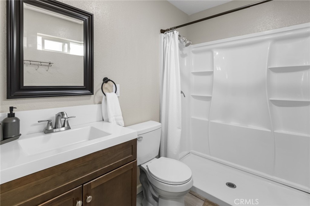 944 West 18th Street Merced, CA 95340 - Photo 8 of 34 a bathroom with a sink a toilet and shower