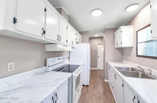 a kitchen with a sink and a refrigerator
