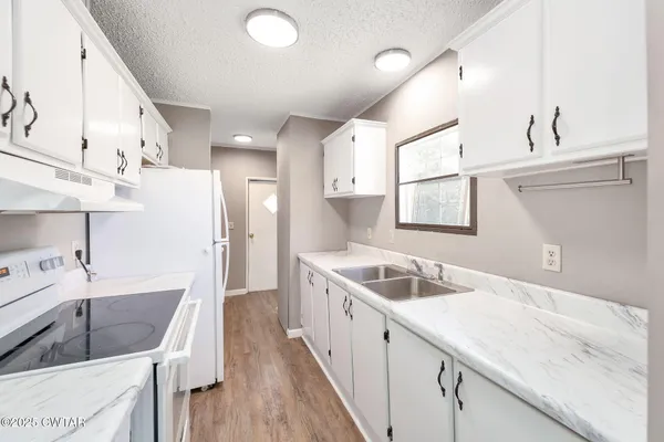 a bathroom with a walk in closet a mirror and a shower