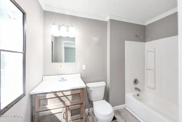 a bathroom with a toilet sink vanity and mirror