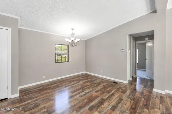 a view of a dining room with furniture and chandelier