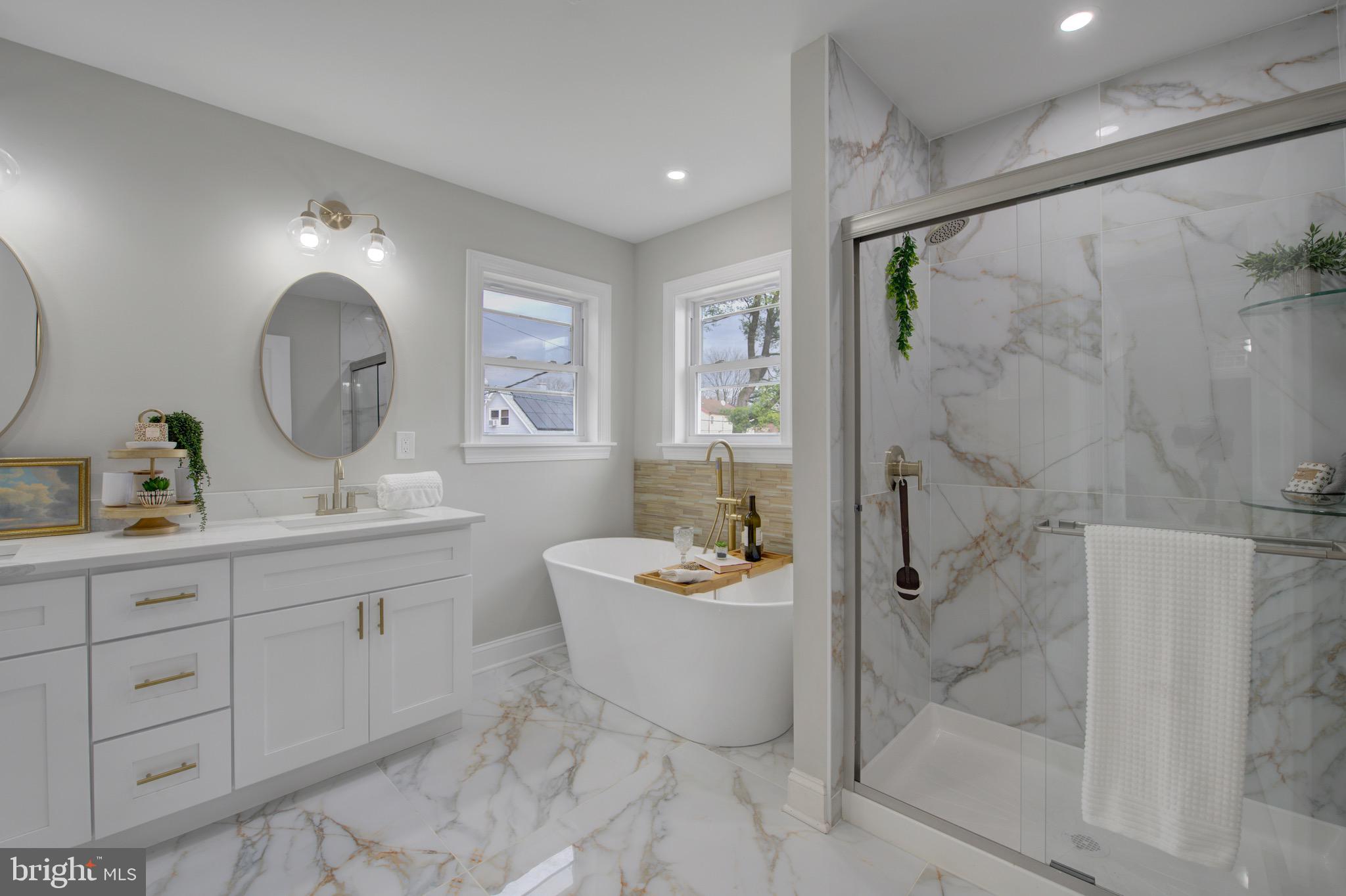 a spacious bathroom with a double vanity sink mirror and bathtub