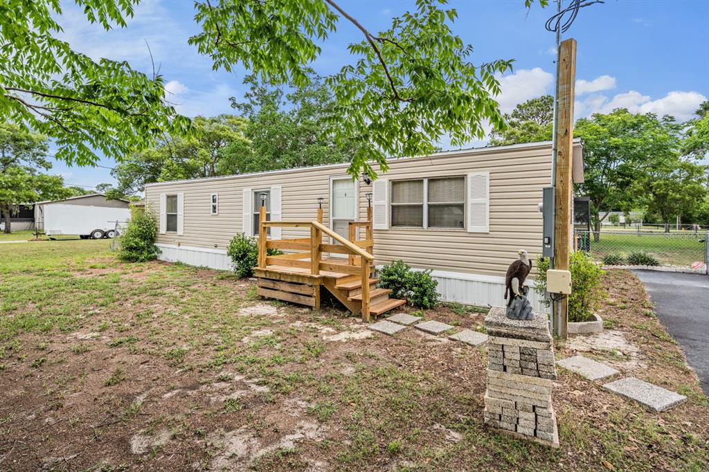 9739 Ray Street Hudson, FL 34669 - Photo 4 of 36 a backyard of a house with table and chairs