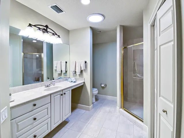 a spacious bathroom with a double vanity sink and a mirror