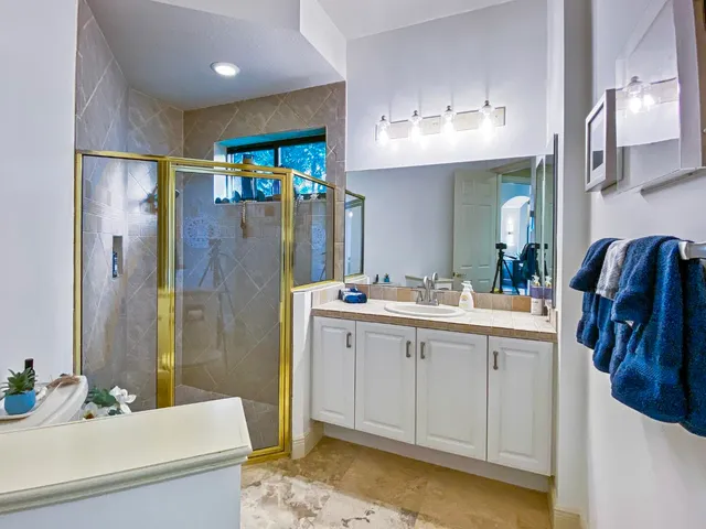 a bathroom with a sink double vanity and shower