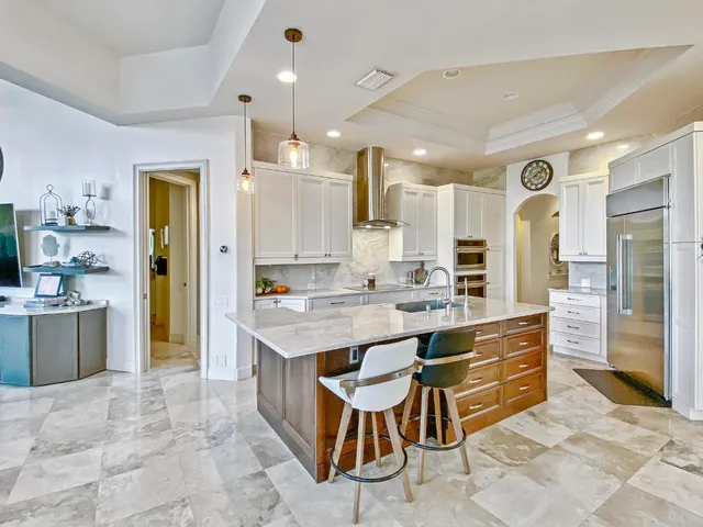 a large kitchen with a large counter top appliances and cabinets