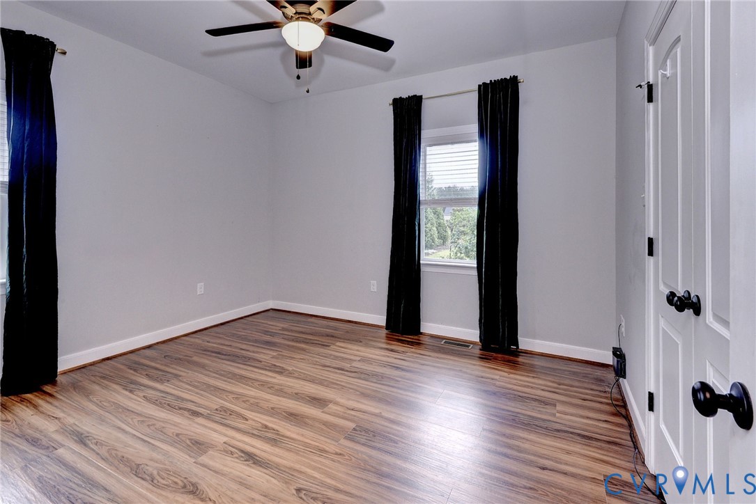 8904 Rock Cedar Road New Kent, VA 23124 - Photo 21 of 37 wooden floor in an empty room with a window