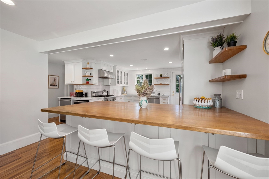 8 Old Salem Road Marblehead, MA 01945 - Photo 3 of 34 a kitchen with stainless steel appliances granite countertop a table chairs and a refrigerator