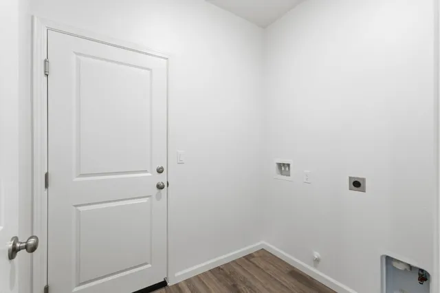 a view of a room with wooden floor