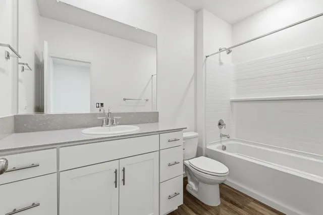 a bathroom with a toilet a sink and bathtub