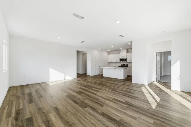 a view of a kitchen with a sink and wooden floor