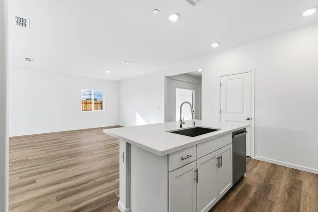 a kitchen with sink and mirror