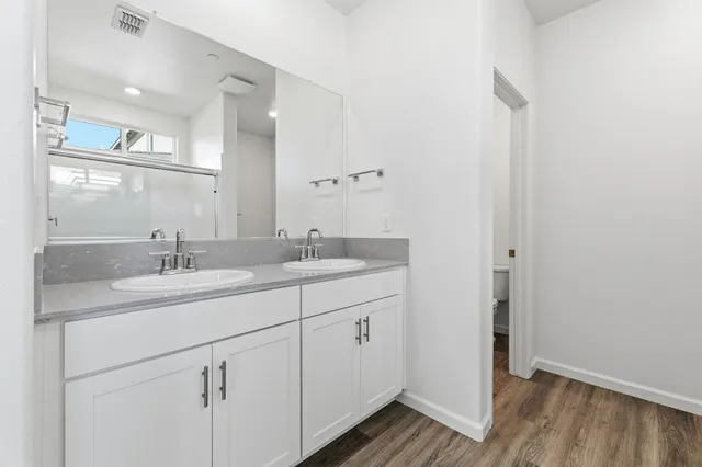 a bathroom with a glass shower door